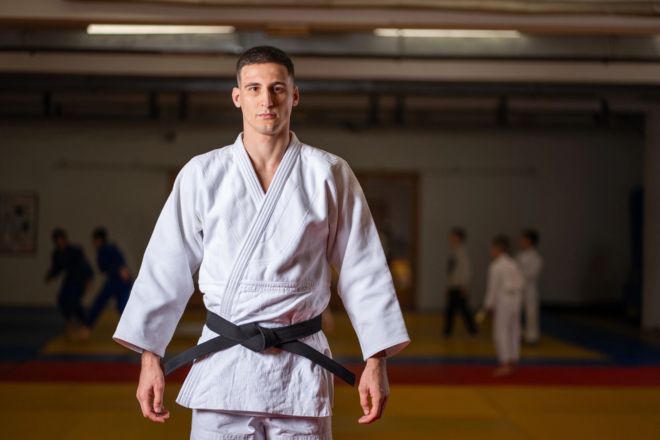 Judo practitioner in dojo representing tournament readiness