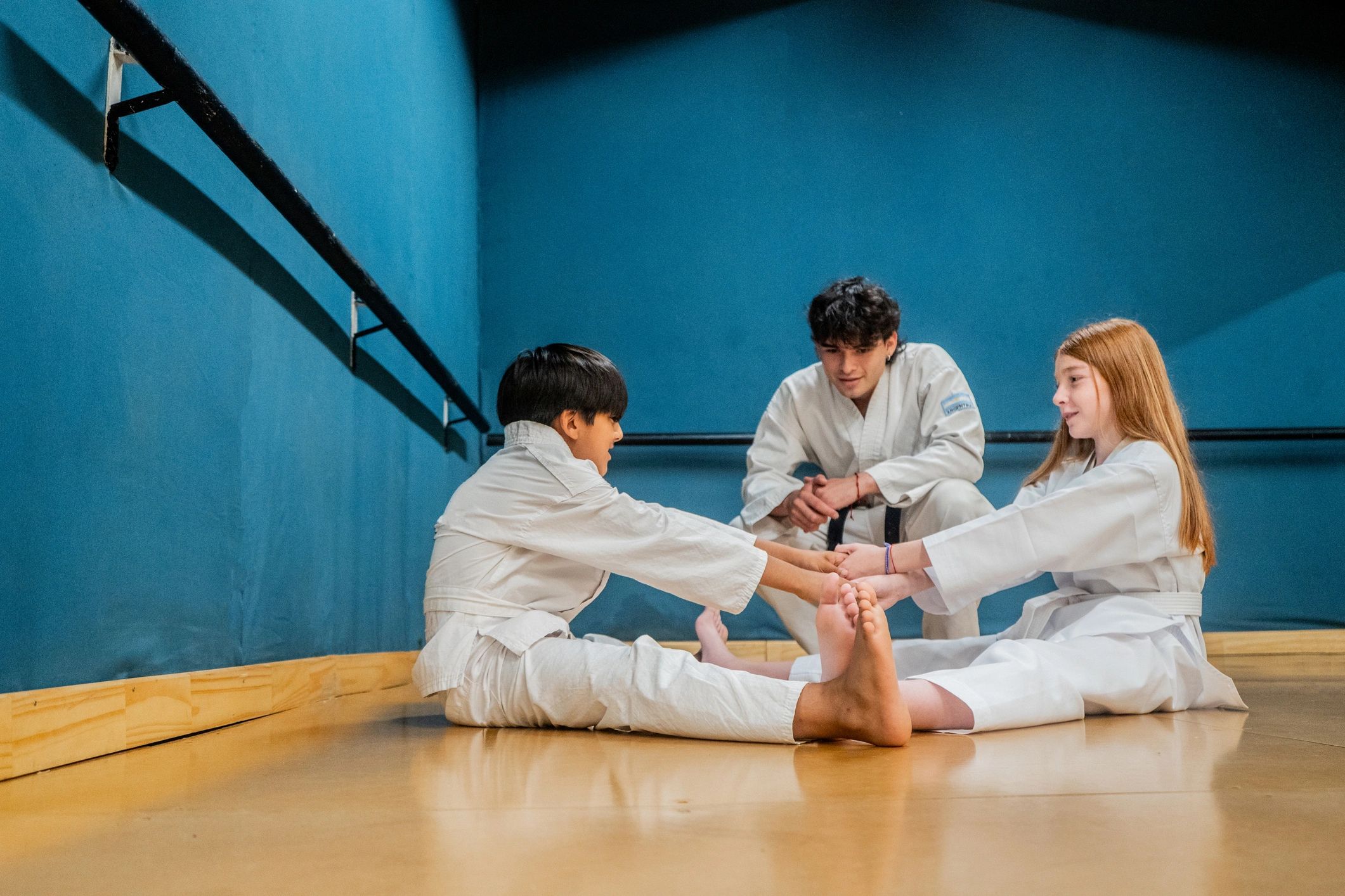 Child students stretching during martial arts class